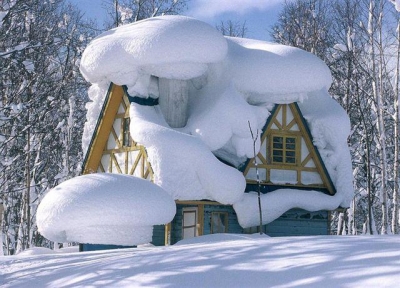 Winter house covered in snow