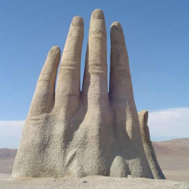 A Sculpture Of A Giant Hand Reaches For The Stars In The Middle Of The 